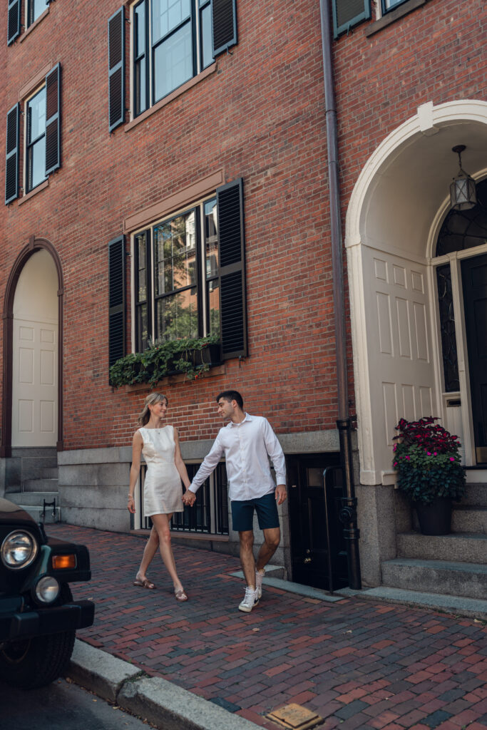 Couple walking down the street in Beacon Hill during Boston engagement photo session